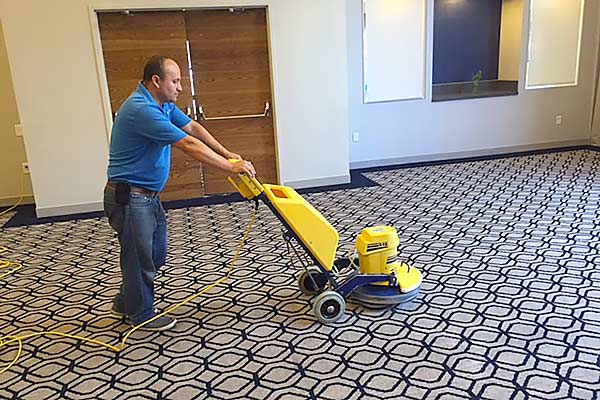 Cleaning a ballroom rug at the Mystic Hilton